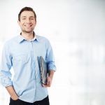 Happy businessman with laptop smiling