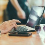 sunglasses-hand-smartphone-desk